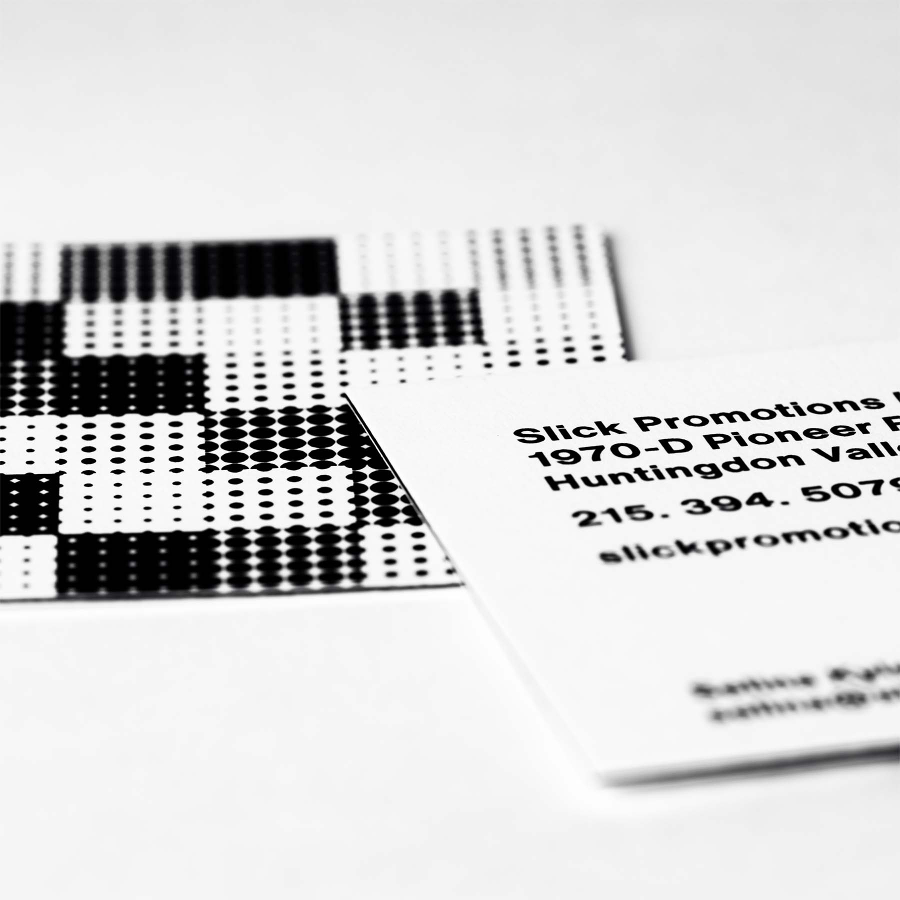 Square business card featuring full Slick Promotions logo on front.
